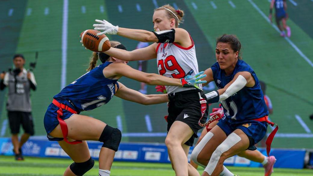 Great Britain players stop an Austria player during the World Games quarter-finals in 2025