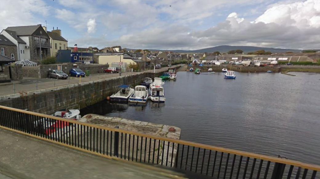 View of a harbour from a bridge showing a concrete platform