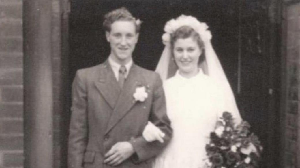 A black and white photograph of a man and woman getting married.