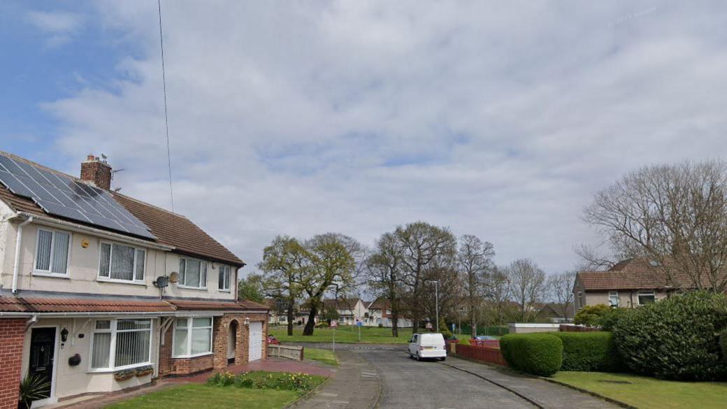 A Google streetview image of houses on Runswick Avenue. A white van is parked on the pavement on the right-hand side of the road.