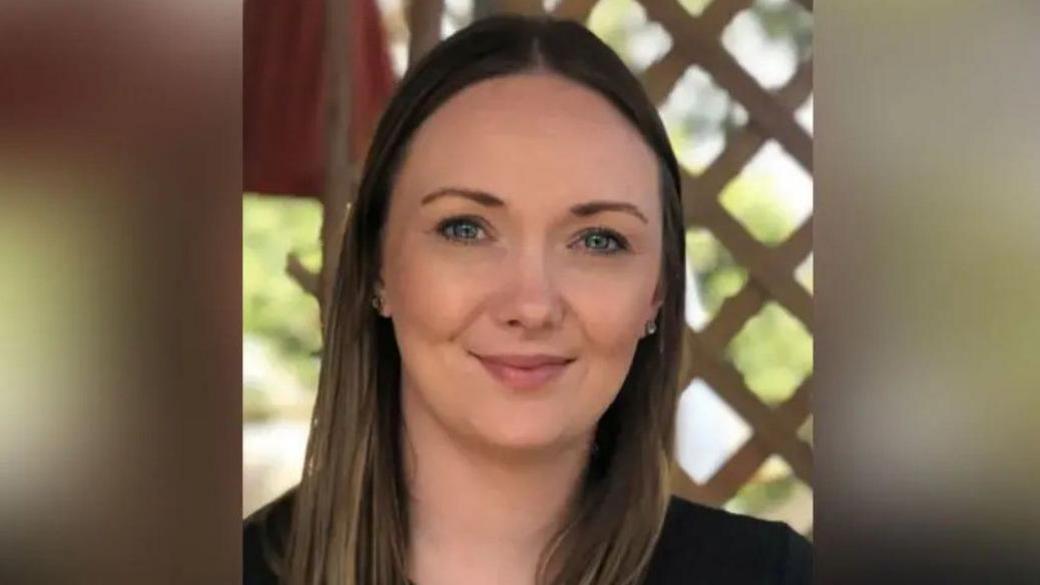 Amy Evans - she has long brown hair and is looking at the camera with a slight smile.