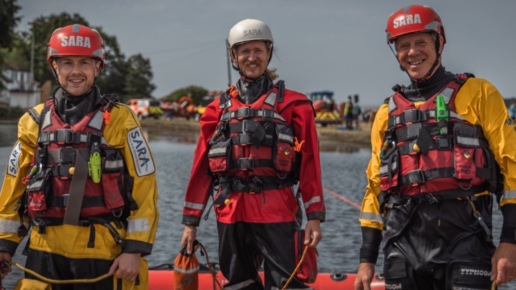 Three SARA crew members dressed in life-saving uniform