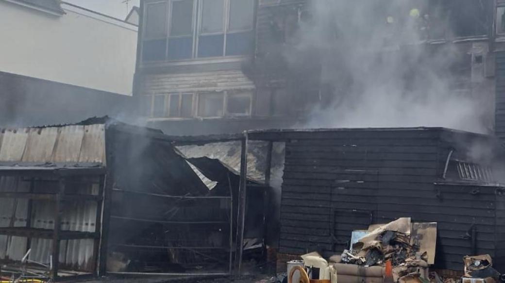 The fire damaged building in Billericay, with smoke billowing