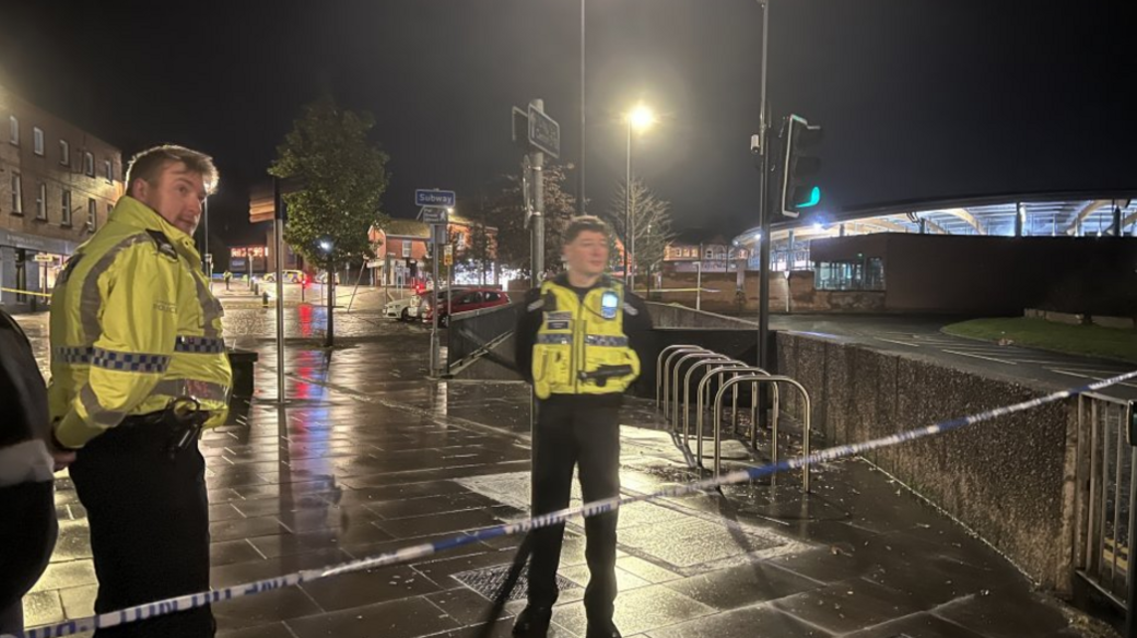 Two police officers stand guard by the cordon in Chester.