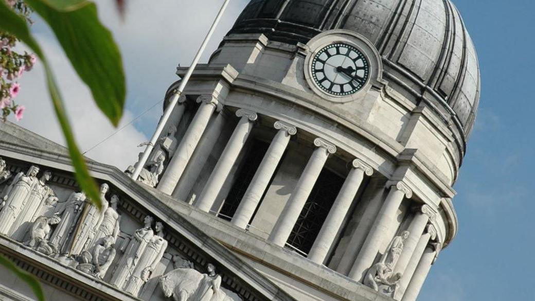 A close up image of the clock on the top of Nottingham's Council House building in the city centre