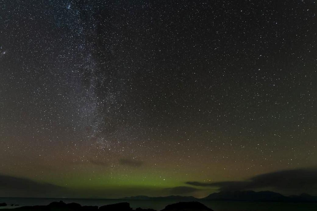 A starry night sky and aurora borealis