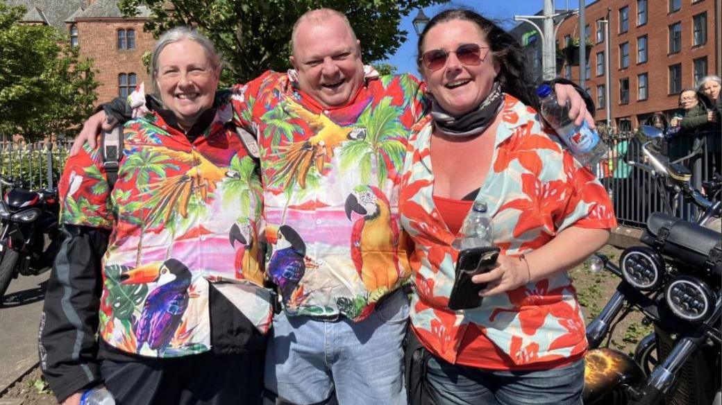  Wendy Foster-Roberts from Cheshire, Gary Wakefield from Cheshire and Chris Sutton from Bury wearing colourful shirts