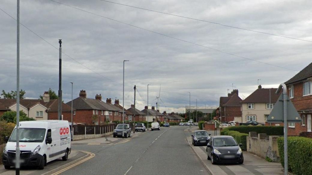 Osmondthorpe Lane junction with Neville Parade in Leeds. The street sign reads Neville Parade