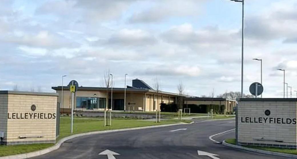 Road entrance with brick-built crematorium in background