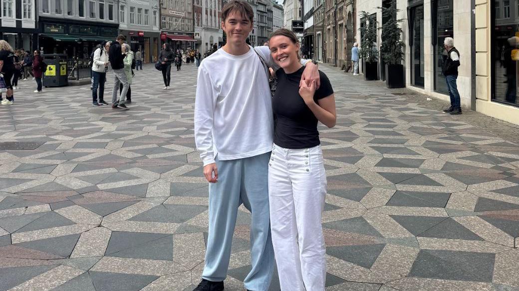Maisie Roberts, who has her hair tied back and is in a black top, with boyfriend Bertie Kinnings, who is in a white T-shirt and has his arms around her.
