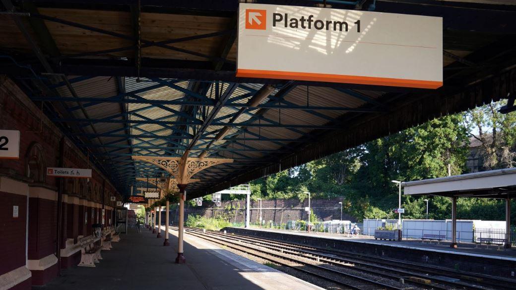 Wellington Train Station which is an old fashioned train station. It has a sign that says Platform 1. 