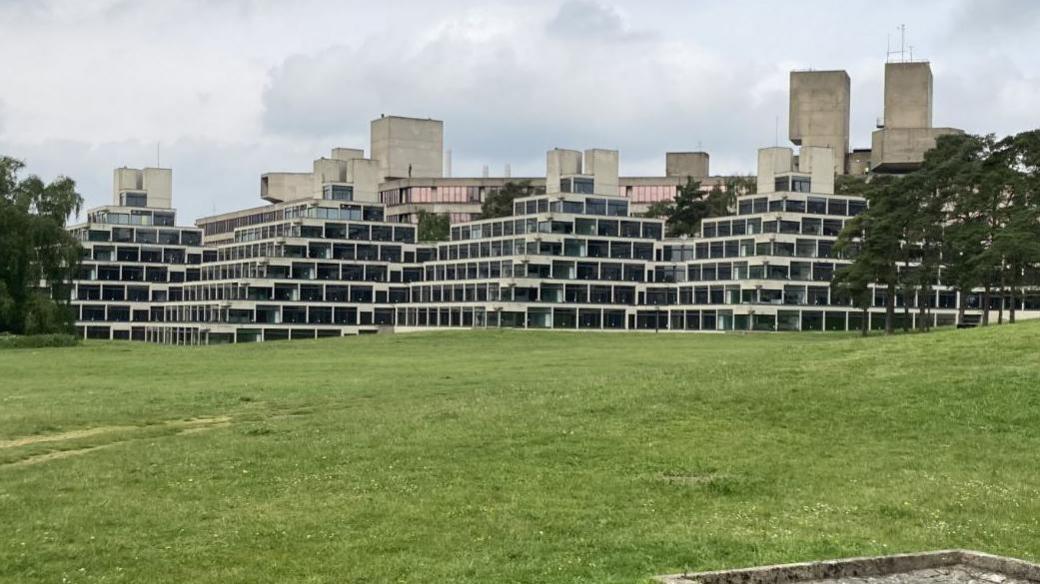 The Ziggurats building at the University of East Anglia, a brutalist building in a diamond structure, with glass windows on each level at the front. 