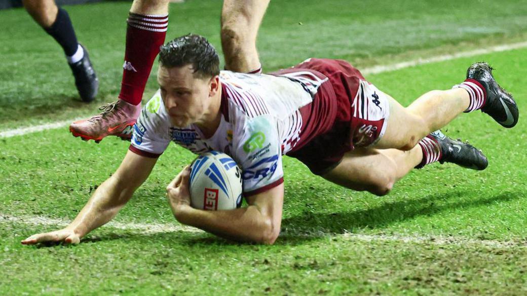 Wigan Warriors' Jai Field diving to score a try