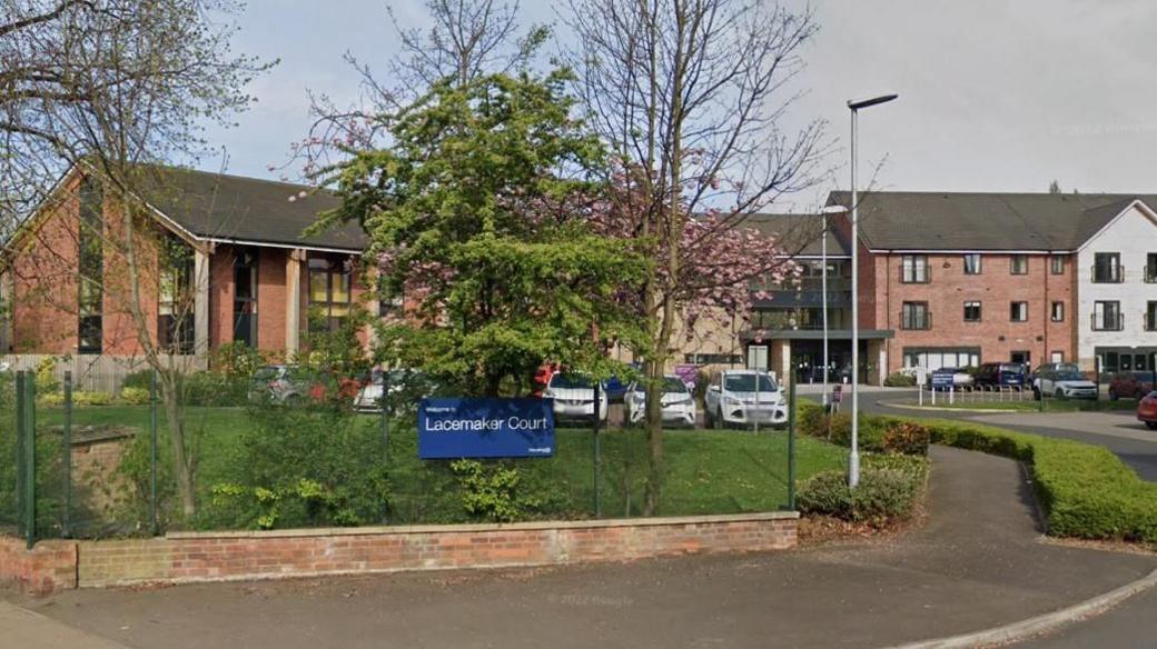 Lacemaker Court, an modern three storey brick complex, made up of an arc of buildings around a lawn area