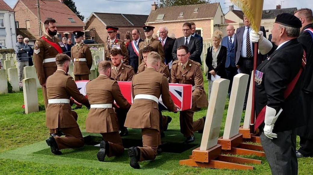 Soldiers lower the coffin of 2nd Lt James Arthur Greenhalgh