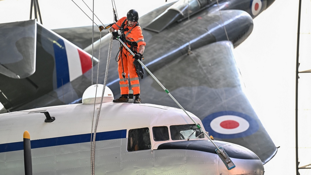 Man cleaning an aircraft