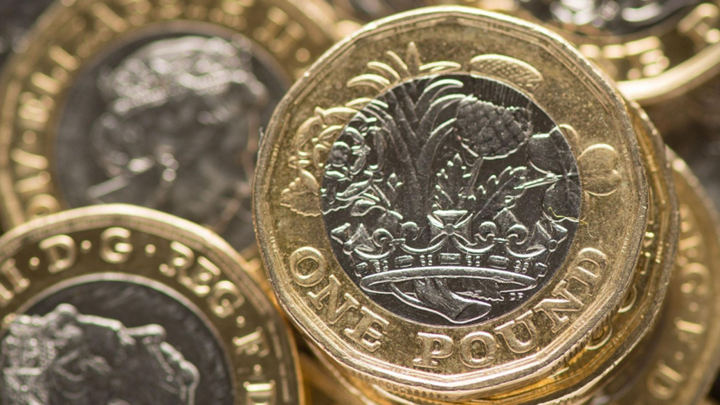 One pound coins in stacks viewed from above