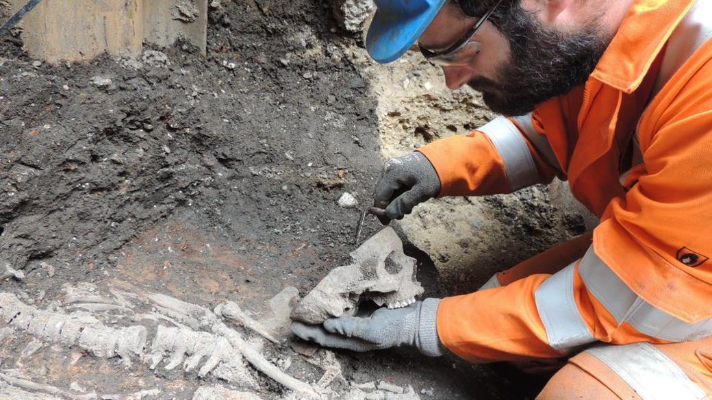 A Crossrail worker excavates a skeleton