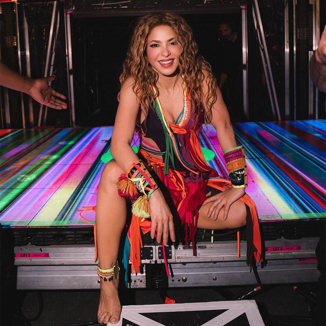 Shakira, in a multi-coloured outfit, poses backstage at her Las Mujeres Ya No Lloran tour in April 2025