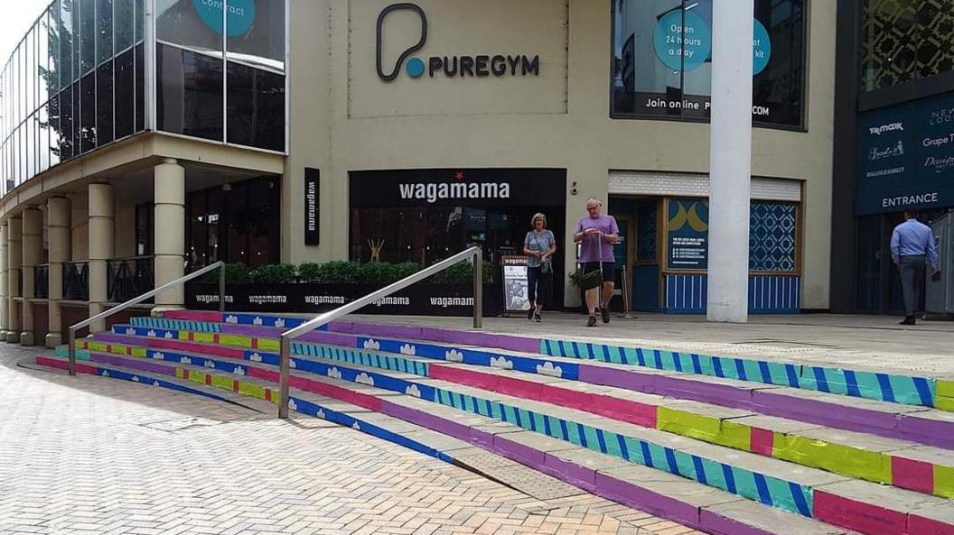 A photo showing the exterior steps into the Buttermarket shopping centre in Ipswich which have been painted an array of colours