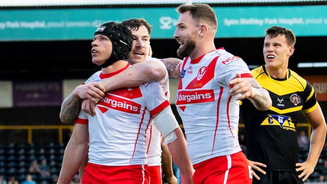 Saints' Jonny Lomax celebrates his try with Cas old boy Daryl Clark