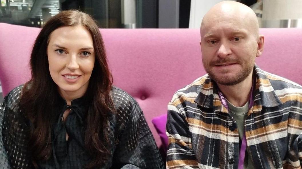 Lauren Lane and Jamie Lonsdale in the green room at BBC Salford sitting on a pink sofa