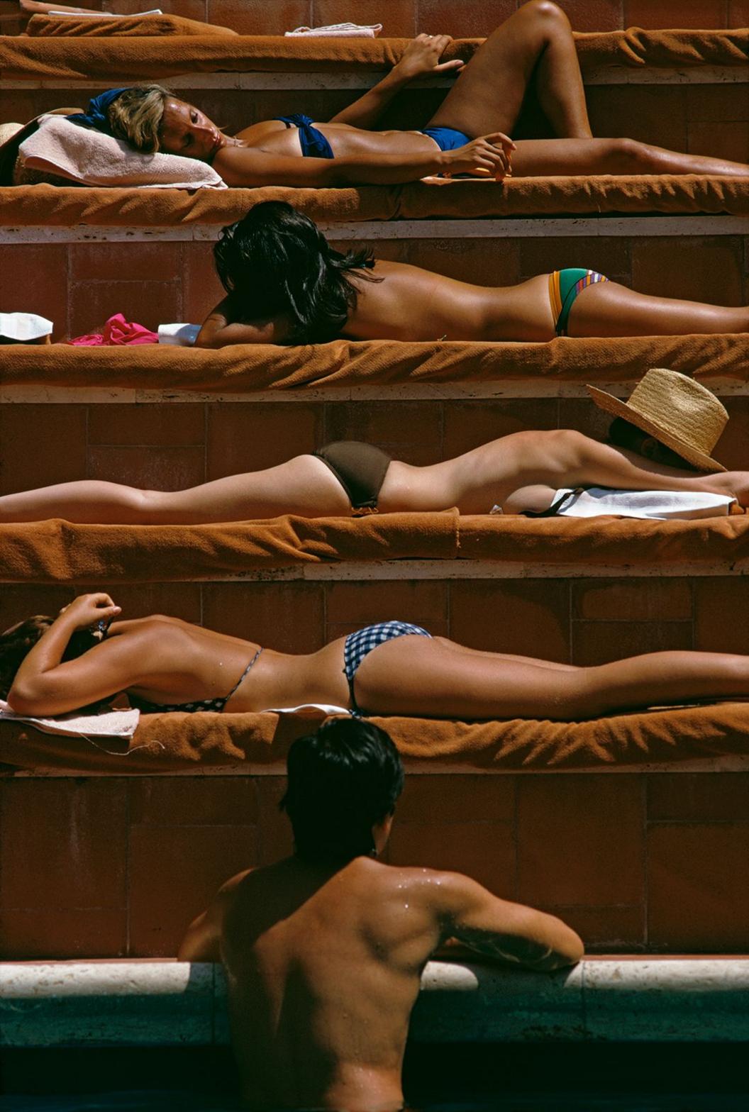 Sunbathers by a swimming pool at the Hotel Punta Tragara on the island of Capri, Italy, August 1974.