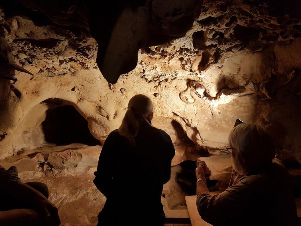 scientists-looking-at-marks-in-cave.