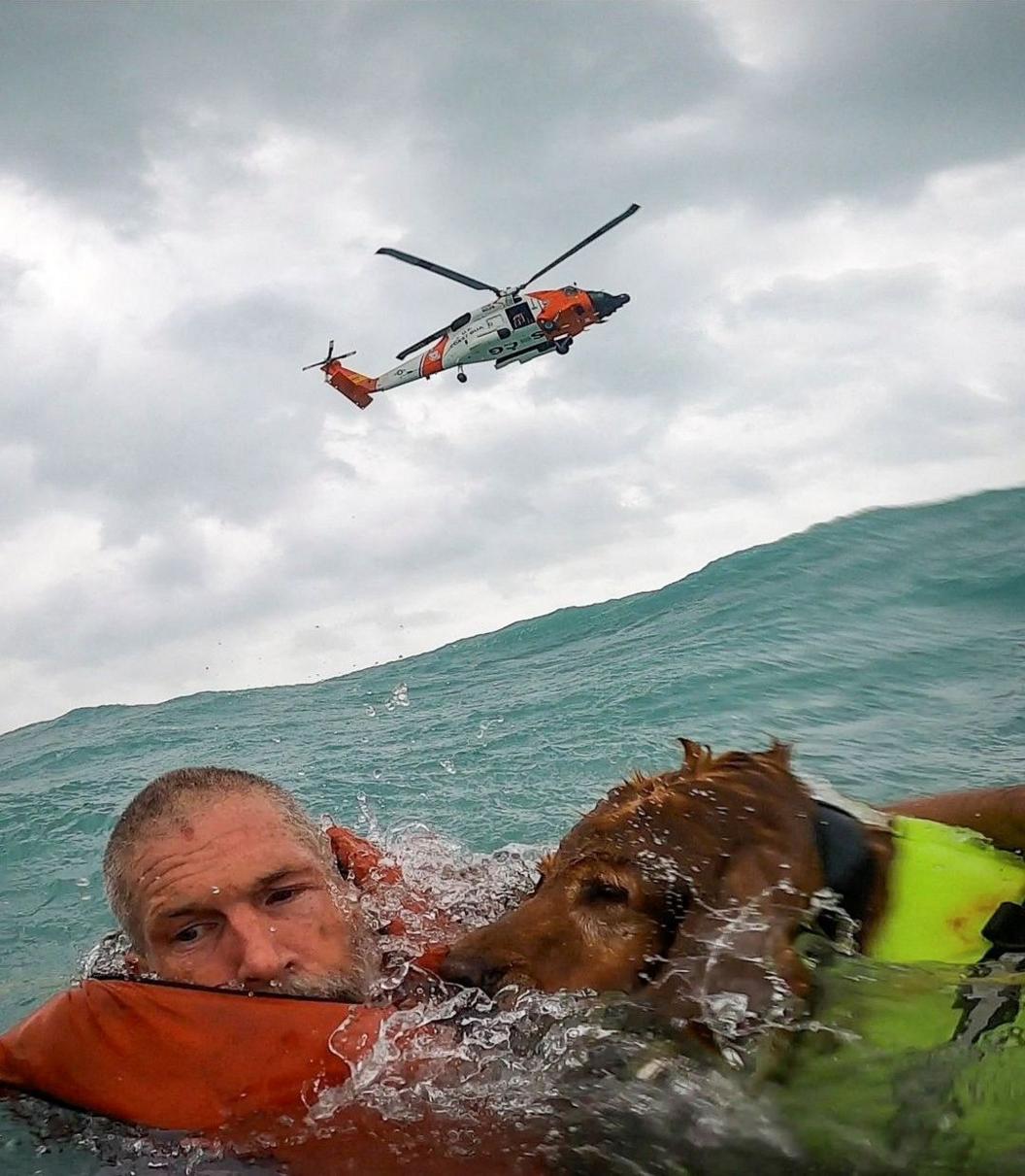 A US Coast Guard Air Station crew rescues a man and his dog during Hurricane Helene after his sailboat became disabled and started taking in water off Sanibel Island, Florida 