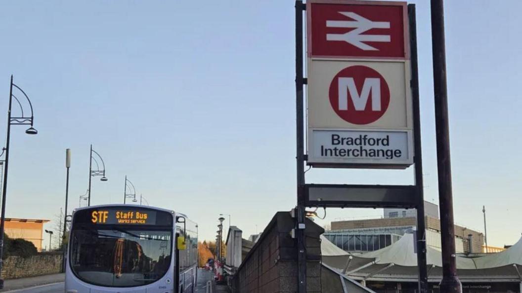 Bradford Interchange bus station sign with bus next to it 