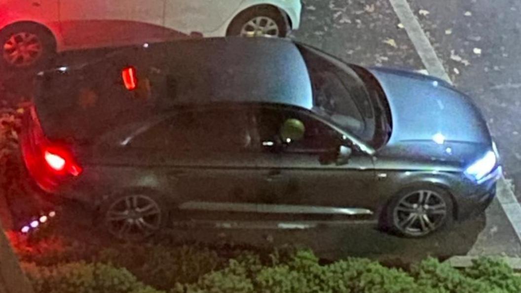 A photo from above shows a car with the driver's window down. A blown up balloon can be seen. 