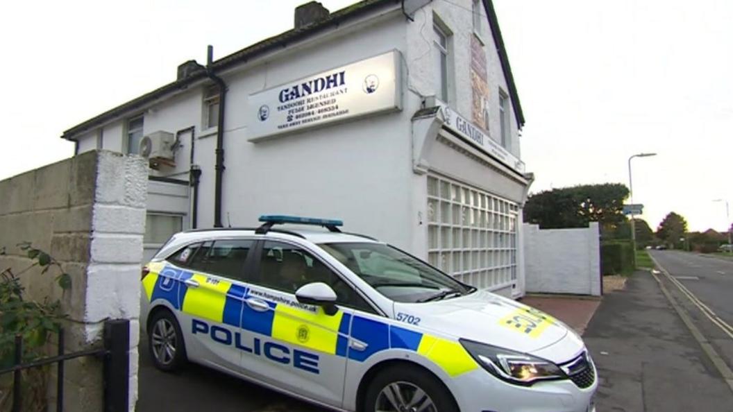 Police car outside Gandhi restaurant