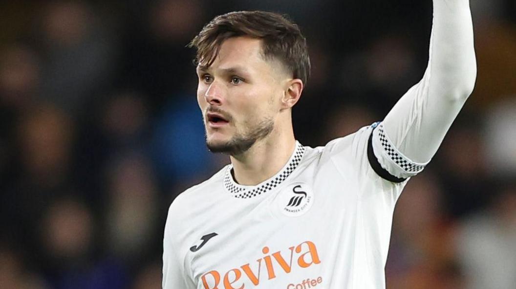 Liam Cullen with one arm raised