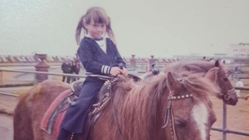 Natalie Pearman on a horse as a young child