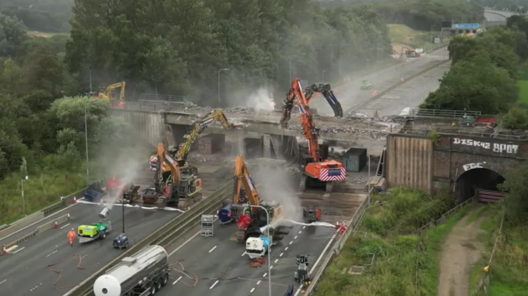 Bulldozers demolish the Castleton bridge over the M62