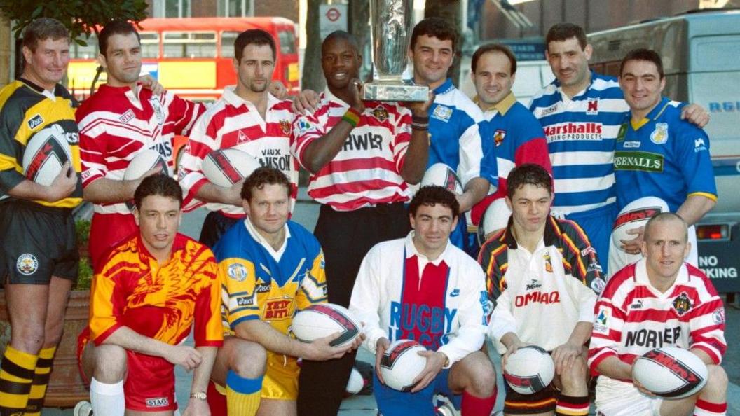 Representatives of the 1996 Super League clubs attend the media and photo shoot - back row is Lee Crooks, Dean Busby, Paul Topping, Martin Offiah, Rowland Phillips, Terry Matterson, Karl Harrison and Paul Cullen. Front row is Mark Aston, Neil Harmon, Patrick Entat, Robbie Hunter-Paul and Shaun Edwards