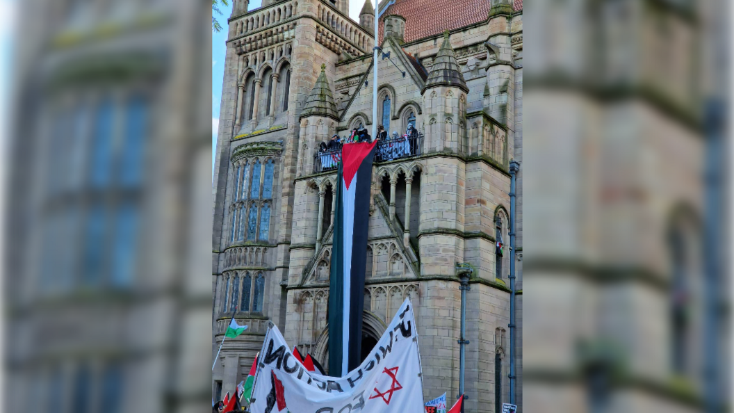 Occupiers on the balcony of the Whitworth building