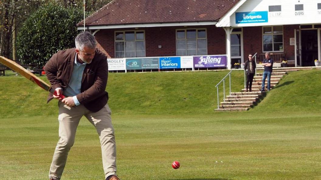 David Skaith plays cricket at a cricket club. He is about to hit the ball, which is on its way towards his bat.