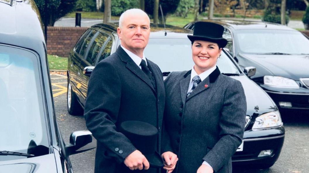 Inez and her father Nigel next to a hearse