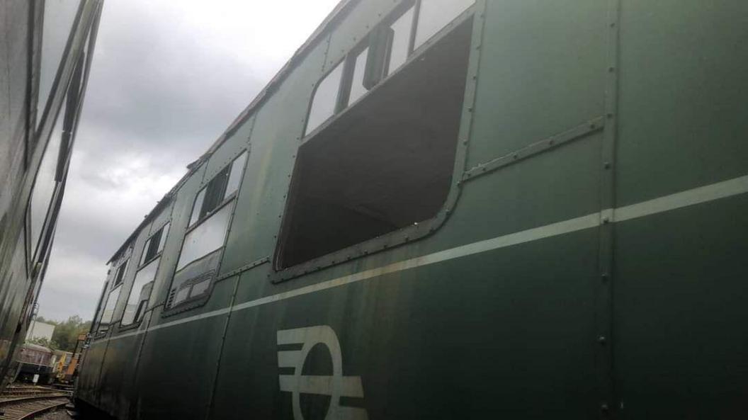 The side of a green vintage steam-hauled carriage