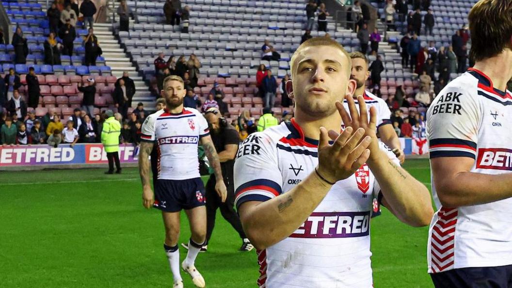 Mikey Lewis applauds after England's game against Samoa at the end of 2024