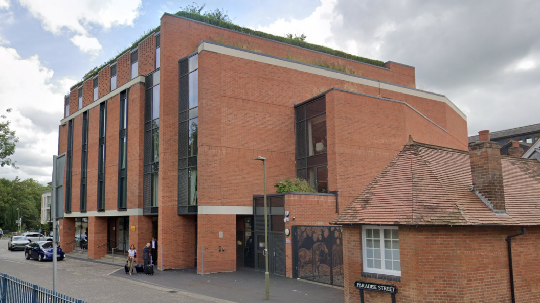 A general view of the six-storey hotel, with barriers to the River Thames running by 