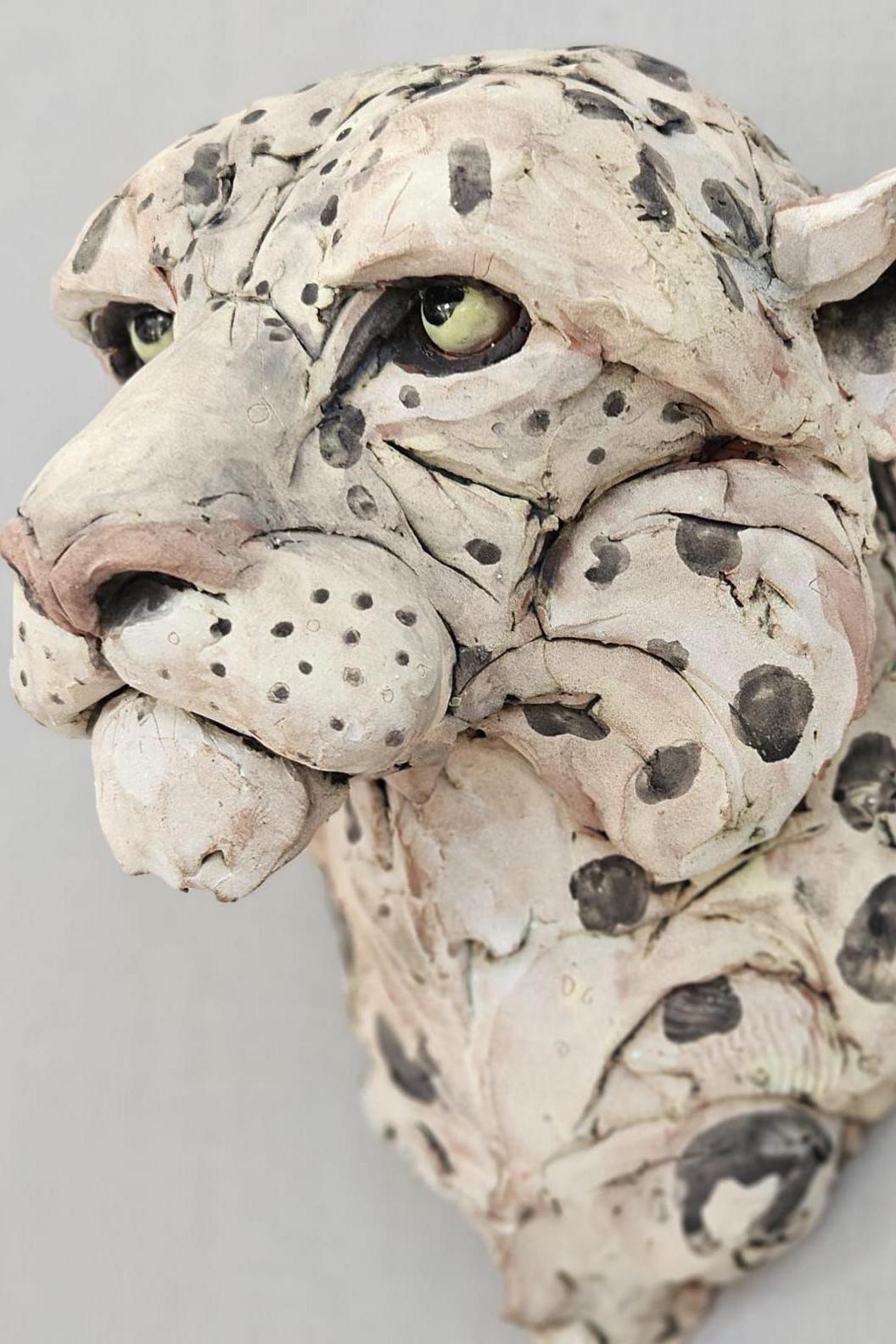 The head of a wooden carved snow leopard 