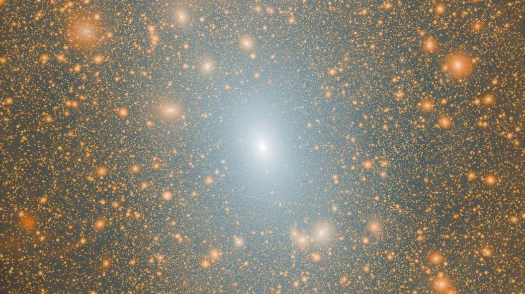A Lambda-cold dark matter (LCDM) cosmological simulation shows the dark matter distribution of a Milky Way mass halo. The Milky Way halo is in the centre. It is white and bright, surrounded by myriad yellow subhalos. Some of those host a satellite galaxy within them.