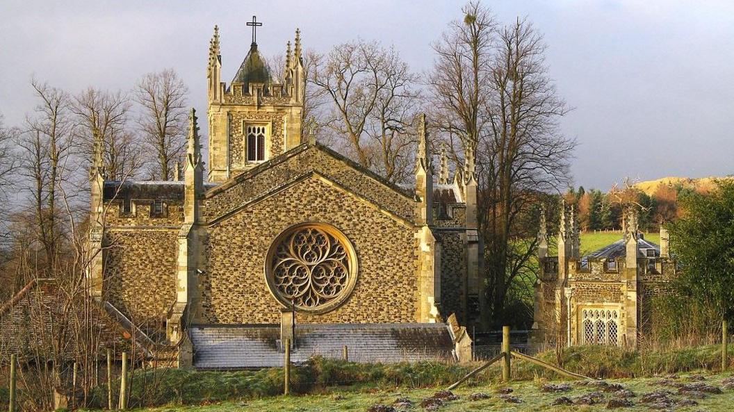 A gothic-style church with a large circular window.