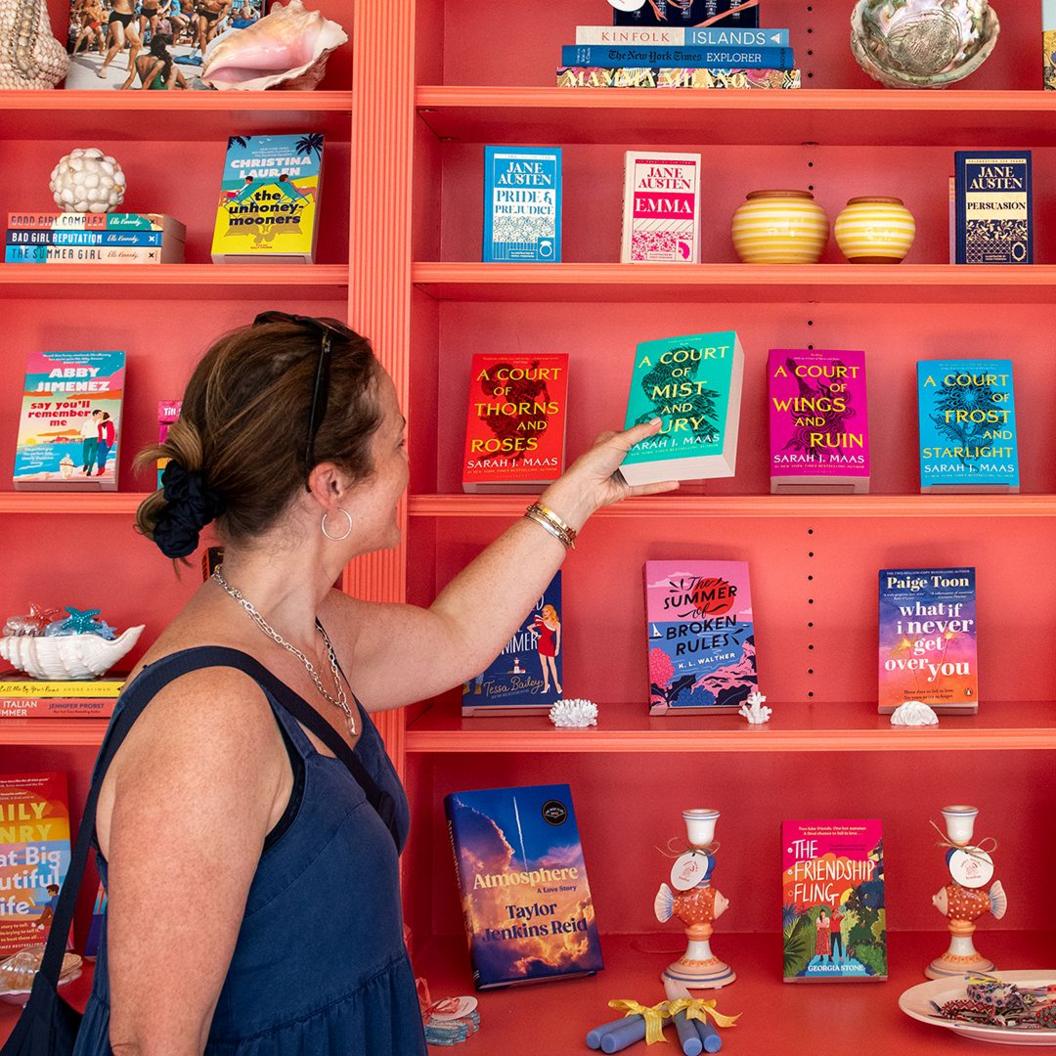 A customer looks at romance novels books in a west London bookshop