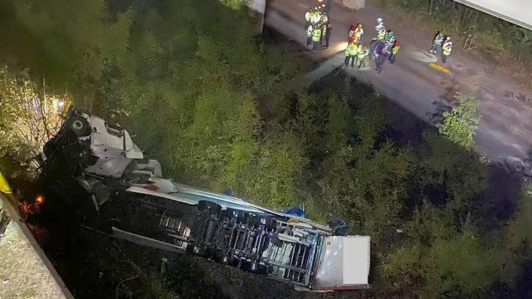 The overturned lorry pictured from above after it fell off the Thelwall Viaduct