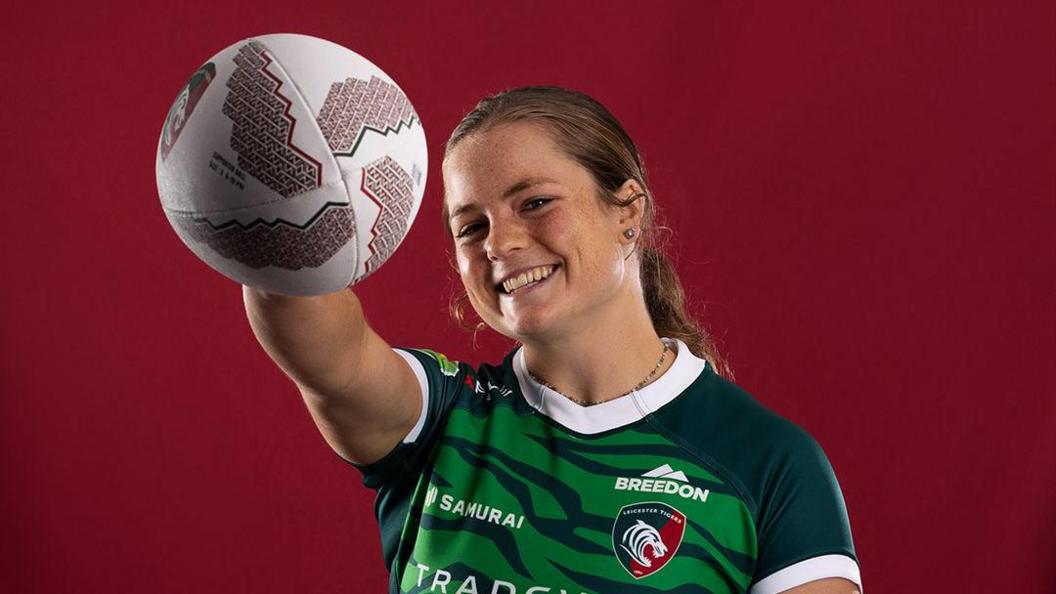 Leicester Tigers' Emily Henrich poses for pictures with a rugby ball in hand