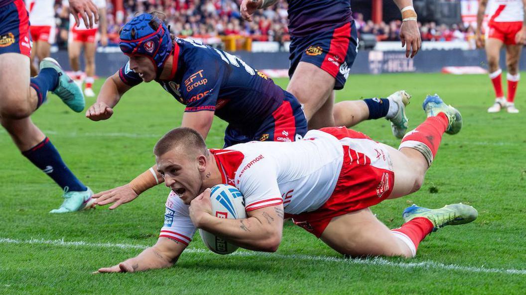 Hull KR player Mikey Lewis dives over the line to score a 