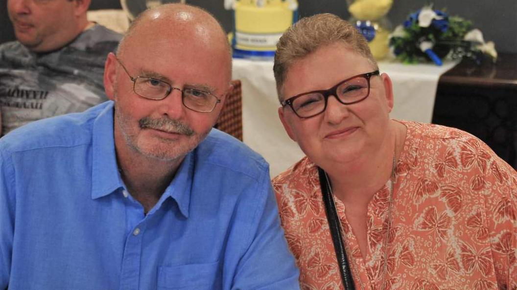 Allan and his wife, Bev, who has glasses and short, blonde hair.